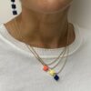 Collier pendentif brique de Lego® rose corail, jaune pastel et bleu marine