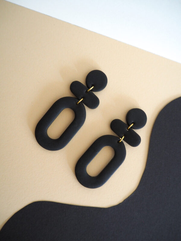 Boucles d'oreilles pendantes noir avec rond, barre horizontale et ovale
