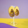 Boucles d'oreilles anneaux entrelacés jaune et motif damier jaune & violet