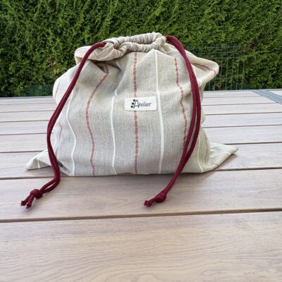 Sac a linge beige à rayures roses pour les vacances ou pour le week end