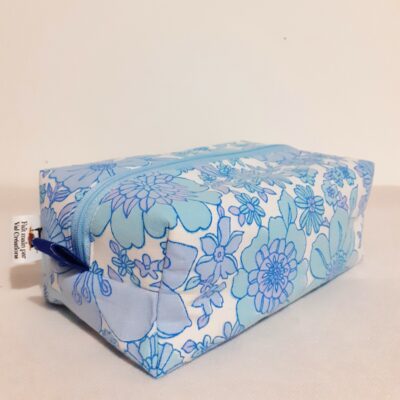 trousse de toilette grosses fleurs bleues pour ranger brosses à cheveux et maquillage.