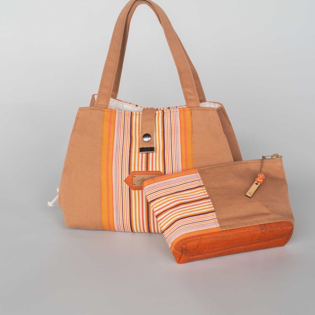 Le sac pochon Eden en toile basque couleur noix unie et toile espadrille Ogi pain d'épices, avec sa trousse assortie.