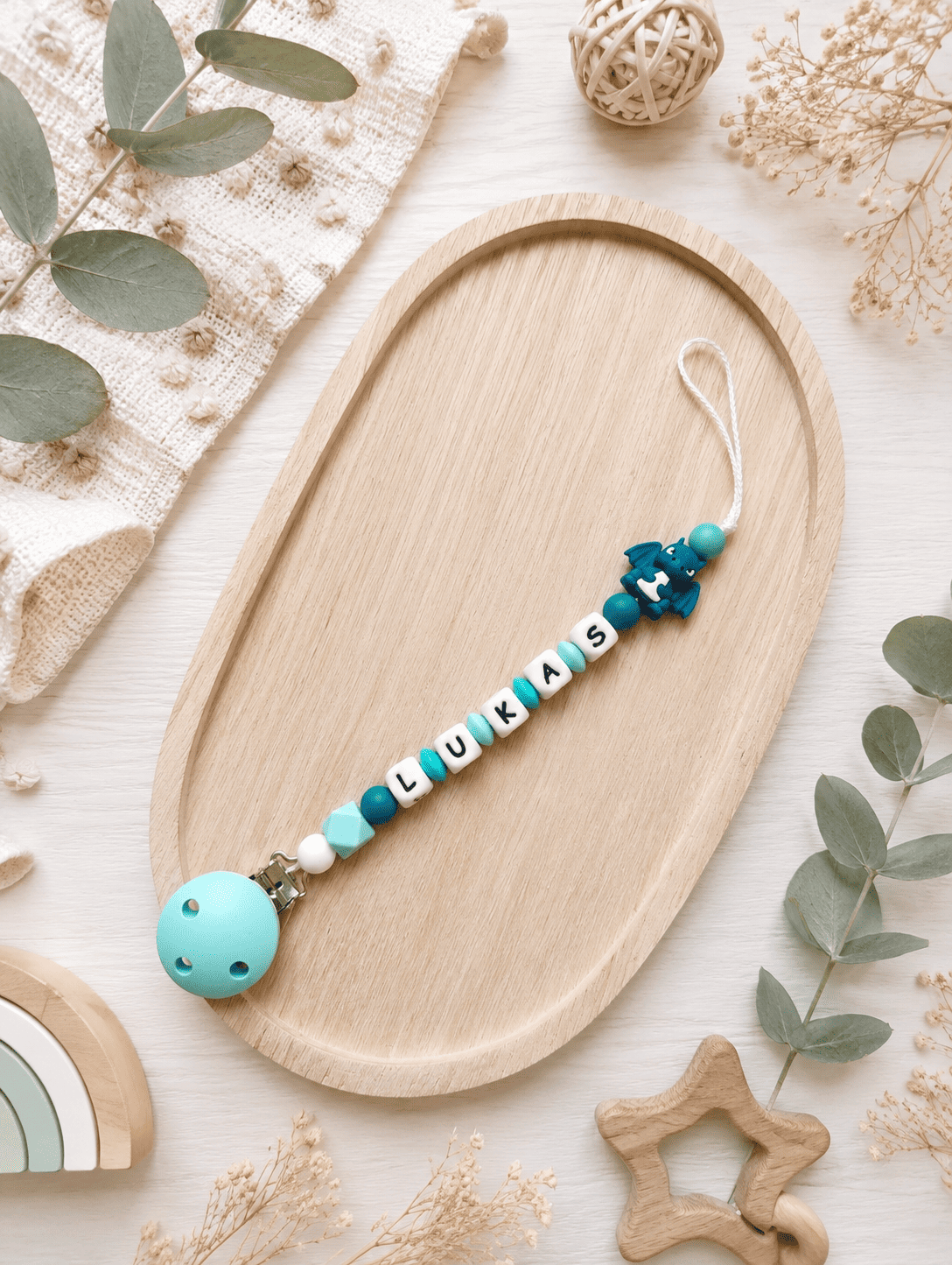 attache tétine dragon turquoise